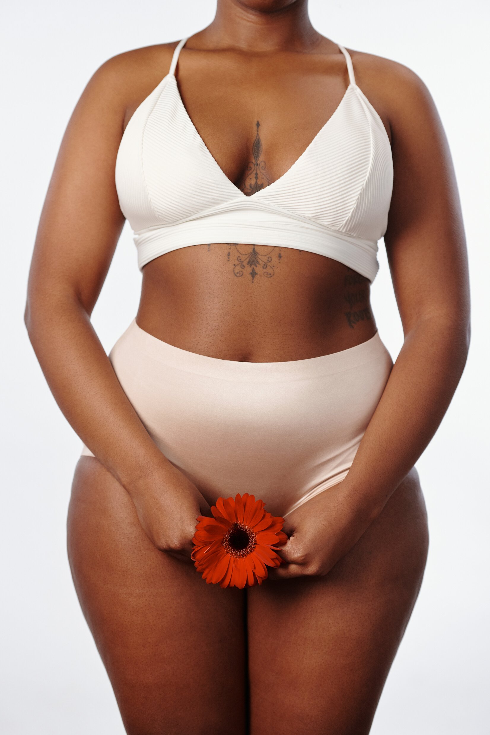 Woman Wearing White Bikini Holding a Flower